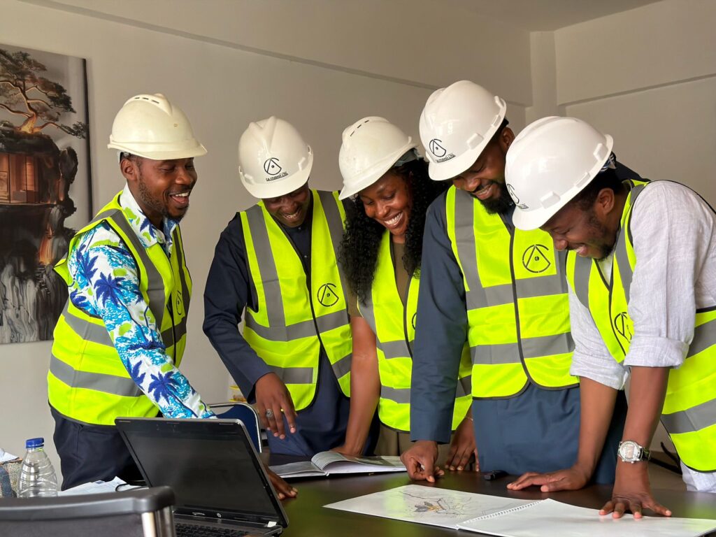 African engineers reviewing construction plans in Abuja
